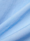 A close-up fabric swatch of the pale blue broadcloth material used for the Pale Blue Broadcloth Camp Shirt. The image highlights the smooth, uniform weave and light blue color of the 100% cotton fabric.