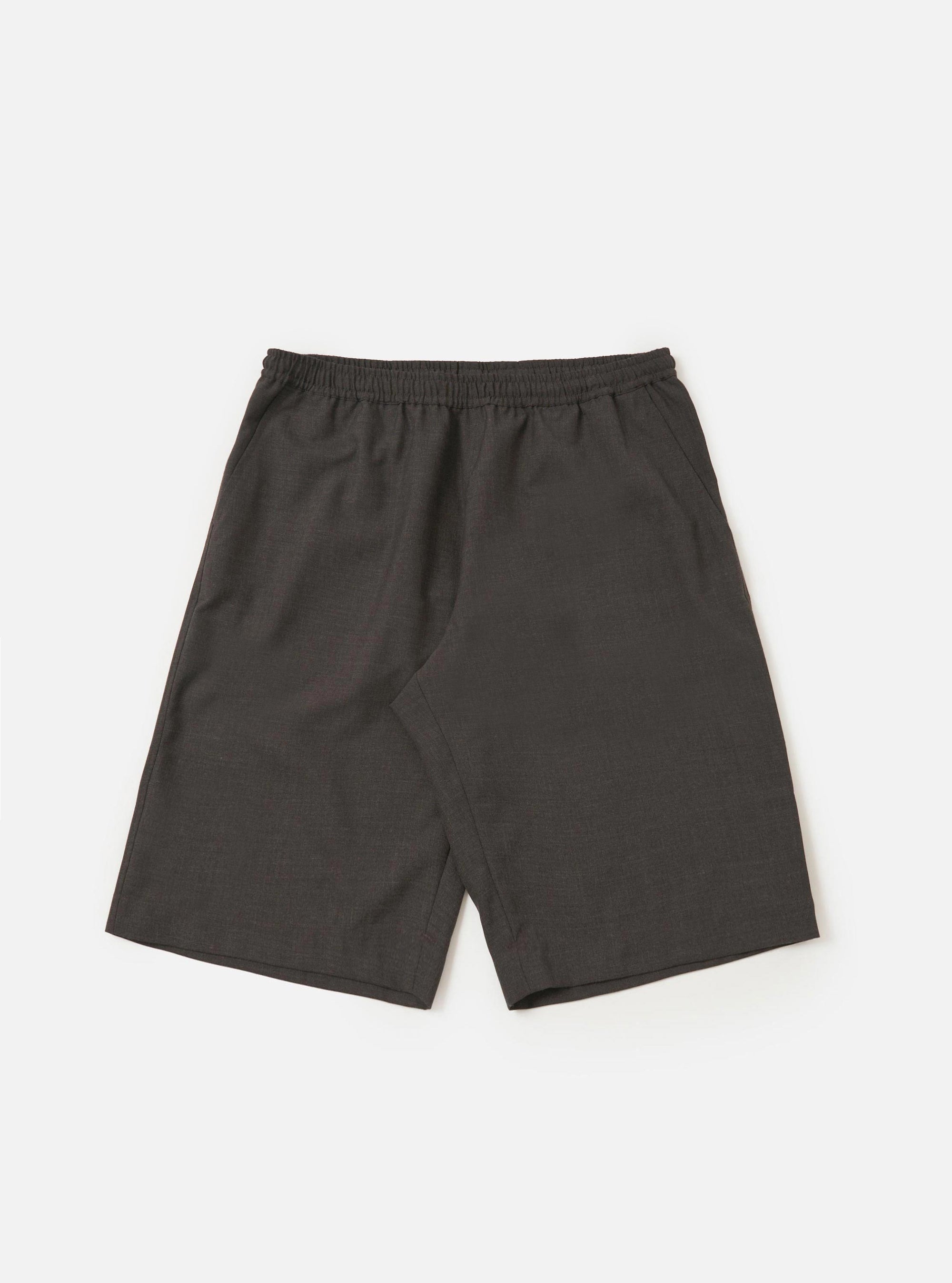 A pair of brown marl tropical suiting vacation shorts is displayed flat against a plain white background. The shorts feature an elasticated waistband with a button closure, side slip pockets, and a relaxed, straight-leg fit.