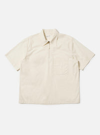 The Ecru Broadcloth Ewan Shirt is shown laid flat against a plain white background. This pullover-style shirt features a classic pointed collar, a short zip-front placket, and two large chest pockets. The long sleeves are positioned at the sides, and the garment is made from a smooth, ecru-colored cotton broadcloth.