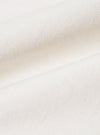A close-up fabric swatch of the Ecru Slub Drill Dizzy Trouser displays the textured, off-white cotton material. The image highlights the characteristic slubby weave and durable drill construction of the fabric.