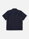 The back of the Navy Paper Touch Cotton S/S Fatigue Shirt is shown from a rear angle, laid flat against a plain white background. The image highlights the short sleeves, a straight hem, and a horizontal yoke across the shoulders.