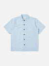 A Sky Blue Paper Touch Cotton S/S Fatigue Shirt is shown laid flat against a plain white background. The short-sleeved overshirt features a classic pointed collar, a full button-down front with tonal buttons, and a single large patch pocket on the left chest. The fabric has a smooth, crisp texture and a straight hem.
