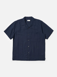 The Navy Linen Cotton Shirting Camp Shirt is displayed flat against a plain white background. This short-sleeve shirt features a camp collar, a single chest pocket on the left side, and a straight hem. The navy blue fabric has a subtle, textured appearance from the linen-cotton blend.
