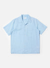 The Pale Blue Linen Cotton Shirting Camp Shirt is displayed flat against a plain white background. The shirt features short sleeves, a relaxed camp collar, and a single large chest pocket on the left side. It has a button-down front and a straight hem with small side splits.
