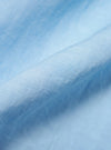 A detailed, close-up fabric swatch of the Pale Blue Linen Cotton Shirting Camp Shirt. The image highlights the textured, slubbed weave of the light blue material, showing the fine intersection of linen and cotton threads.