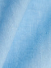 A detailed, close-up fabric swatch of the Pale Blue Linen Cotton Shirting Bakers Overshirt shows the textured weave of the light blue material. The image highlights the natural slub and grain of the linen-cotton blend against a neutral, blurred background.