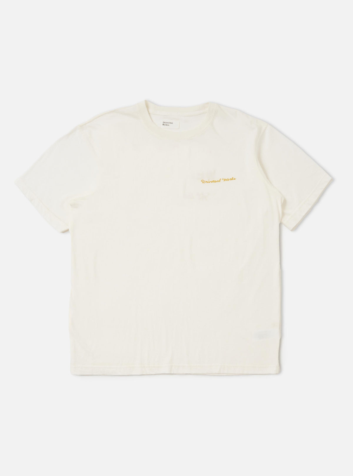 An ecru-colored Ecru Single Jersey Wish Wish You Were Here Tee is displayed flat against a plain white background. The short-sleeved t-shirt features a crew neck and a small graphic print on the left chest.