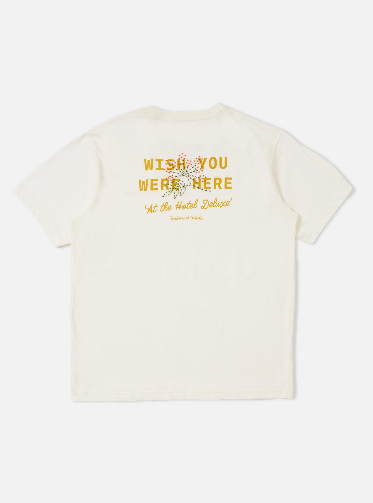 The back of the Ecru Single Jersey Wish Wish You Were Here Tee is displayed flat against a plain white background. The short-sleeved t-shirt features a large printed graphic on the back with Wish You Were Here text and a hand-embroidered floral spray overlay.