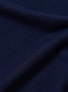 A close-up, square fabric swatch of the Navy Single Jersey Wish Wish You Were Here Tee is shown, detailing the textured navy blue cotton material. The image focuses on the fine knit of the single jersey fabric, showcasing its color and soft surface.