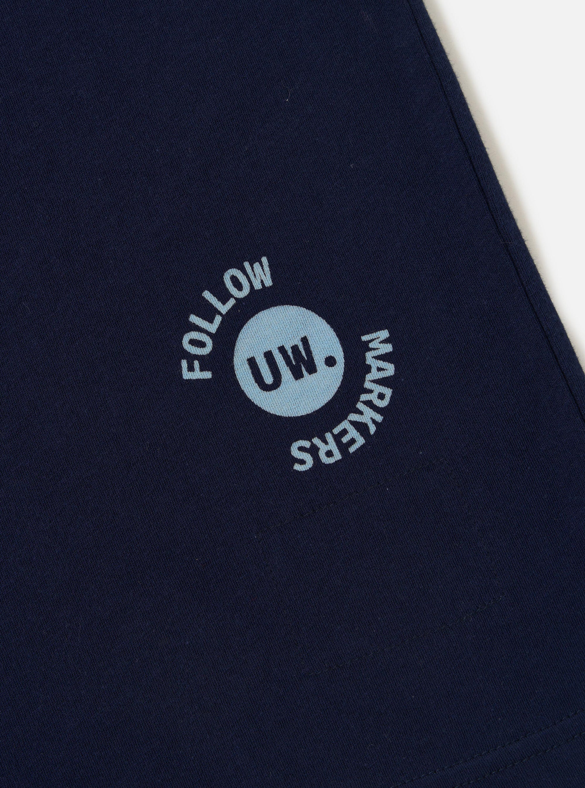 The Navy Single Jersey Trail Trail To Hotel Delux Tee is shown from a rear perspective, laid flat against a plain white background. The image highlights the clean finish of the back of the navy blue cotton t-shirt, including the ribbed crew neck and straight hem.