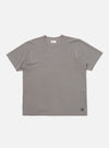 A mid-grey piquet core tee is shown laid flat against a solid white background. The short-sleeved t-shirt features a classic crew neck with a self-bound collar and a straight hem, highlighting the textured piquet cotton fabric.