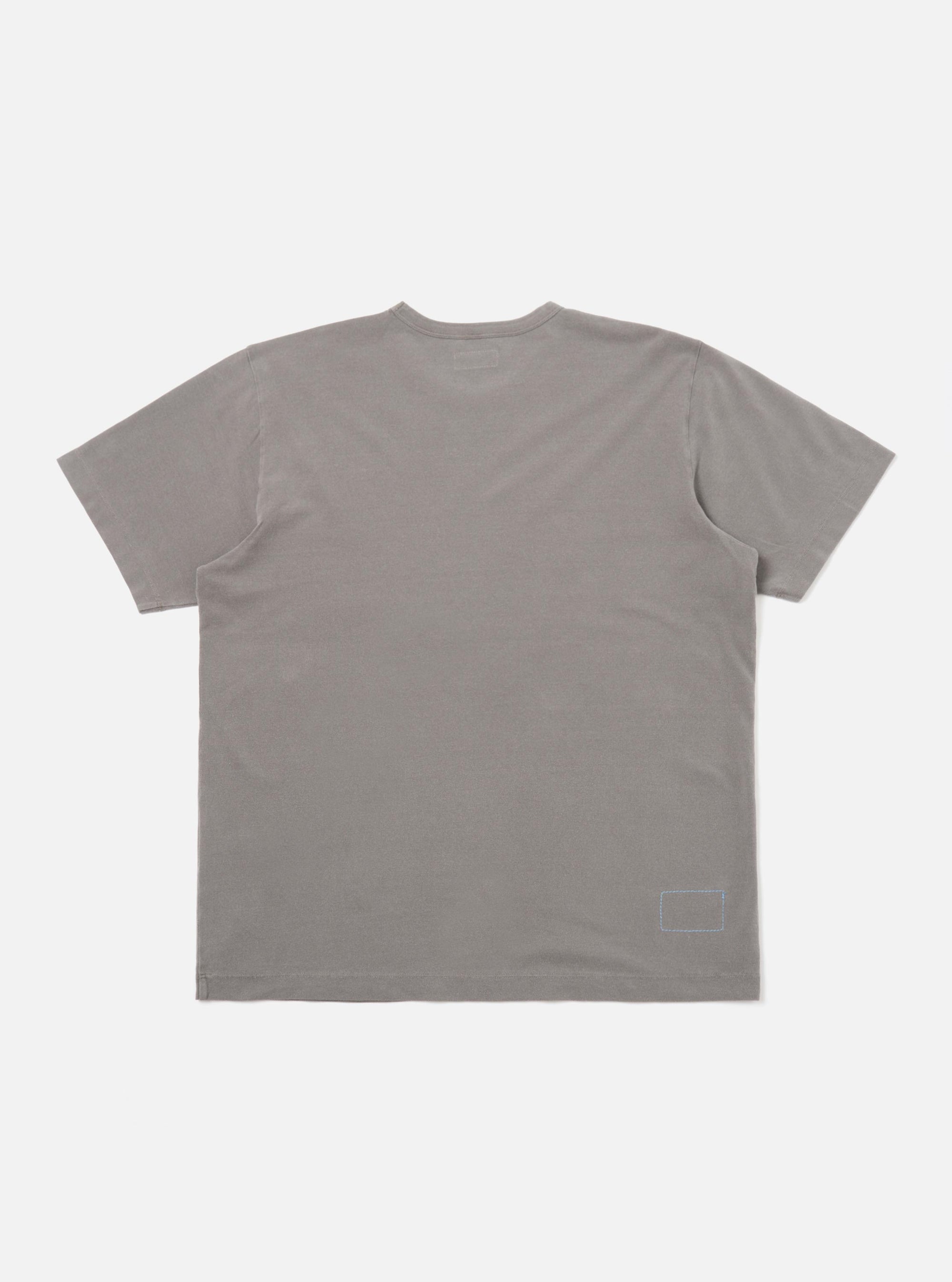 The Mid Grey Piquet Core Tee is shown from the back, laid flat against a plain white background. The image highlights the short sleeves and the straight hem of the textured grey fabric.