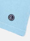 The Pale Blue Piquet Core Tee is shown from the back, laid flat against a plain white background. The image highlights the short sleeves, straight hem, and the textured piquet cotton fabric.