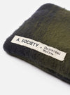 Product shot showing the A. SOCIETY x Universal Works Black Hollywood Sunglasses placed next to a protective olive fabric pouch against a clean white studio background, detailing the dark frame.