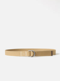 The Sand Canvas O Ring Belt on a white background. The belt is made of sand-colored canvas with a silver O-ring buckle and brown leather detail.