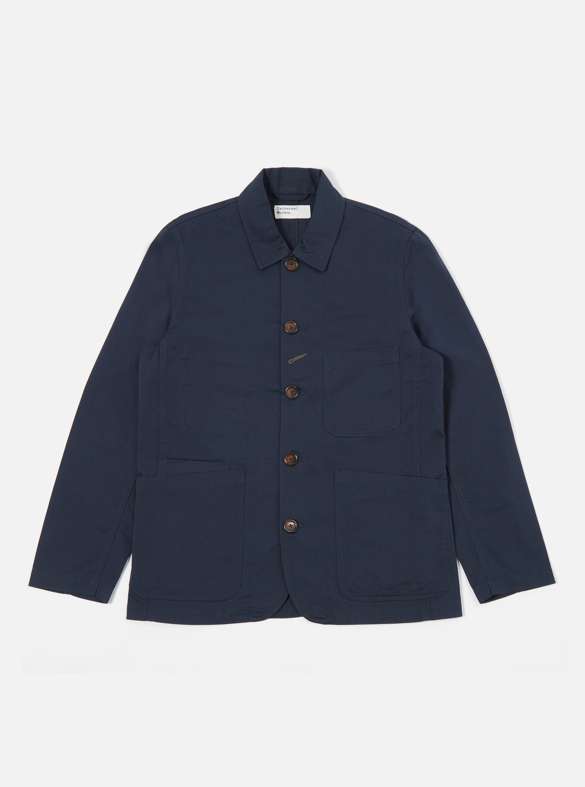 The Navy Twill Bakers Jacket is displayed on a white background. The jacket is a dark navy color and has brown buttons. It has a relaxed fit and is made of a twill material.