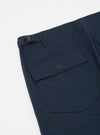 Close-up of the Navy Twill Fatigue Pant (Undarted) on a white background. Shows the twill fabric, side pocket with button, and adjustable waist buckle.