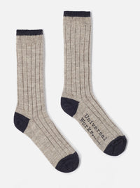 Two Stone Wool Hike Sock on a white background. The socks are ribbed and have a dark navy toe and top. The words "Universal Works" are printed on one sock.
