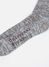 Close-up of a Cornish Blue Cotton Everyday Stripe Sock on a white background. The sock features a blue and brown stripe pattern and the words "Universal Works".
