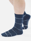 Close-up of a model wearing Navy Tie Dye Knit Slub Sock on a white background. The sock is navy with white stripes and has a ribbed texture.