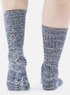 Close-up of a model wearing Navy Slub Knit Slub Socks. The socks are a textured navy and white knit. Shot on a white background.