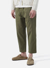 Model wearing Light Olive Twill Hi Water Trouser on a white background. The twill trousers are paired with suede Birkenstocks.