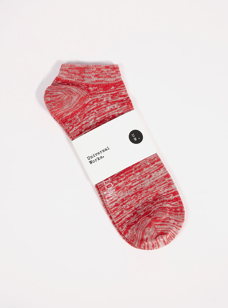 A Red Slub Knit Ankle Slub Sock on a white surface. The sock features a red and white slub knit pattern and is packaged with a white label.
