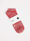A Red Slub Knit Ankle Slub Sock on a white surface. The sock features a red and white slub knit pattern and is packaged with a white label.