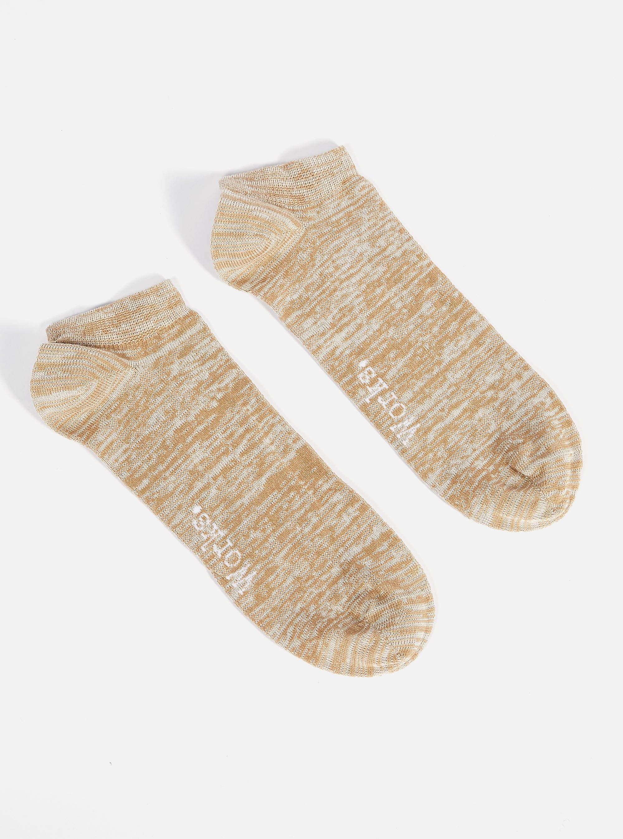 Two Dark Sand Slub Knit Ankle Slub Socks are displayed on a white background. The socks are knit with a textured slub yarn in a dark sand color with white accents.