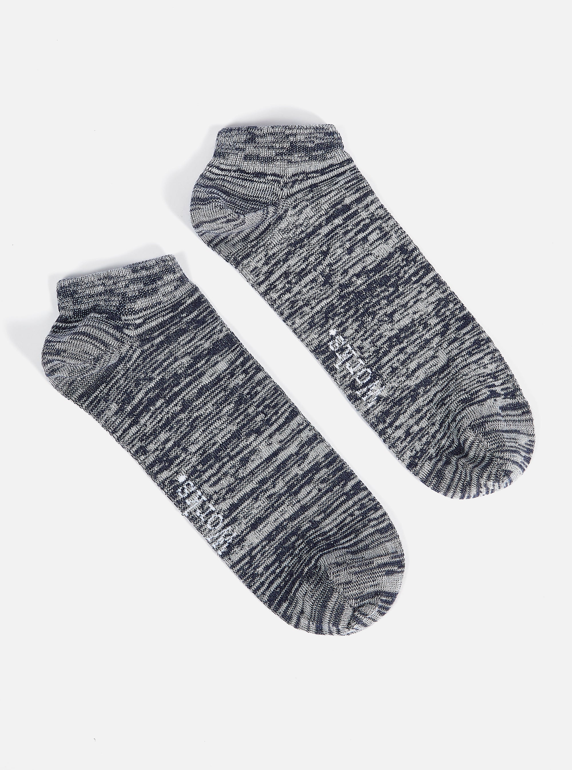 Two Navy Slub Knit Ankle Slub Sock on a white surface. The socks are a blend of navy and white knit, perfect for a casual, comfortable fit.