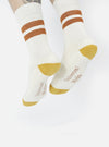 Close-up of Ecru/Orange Cotton Rib Sport Sock on a model against a white background. The sock features orange stripes and a ribbed texture.
