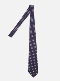 Close-up of a Navy Dot Print Tie on a white background. The tie is navy with white dots.